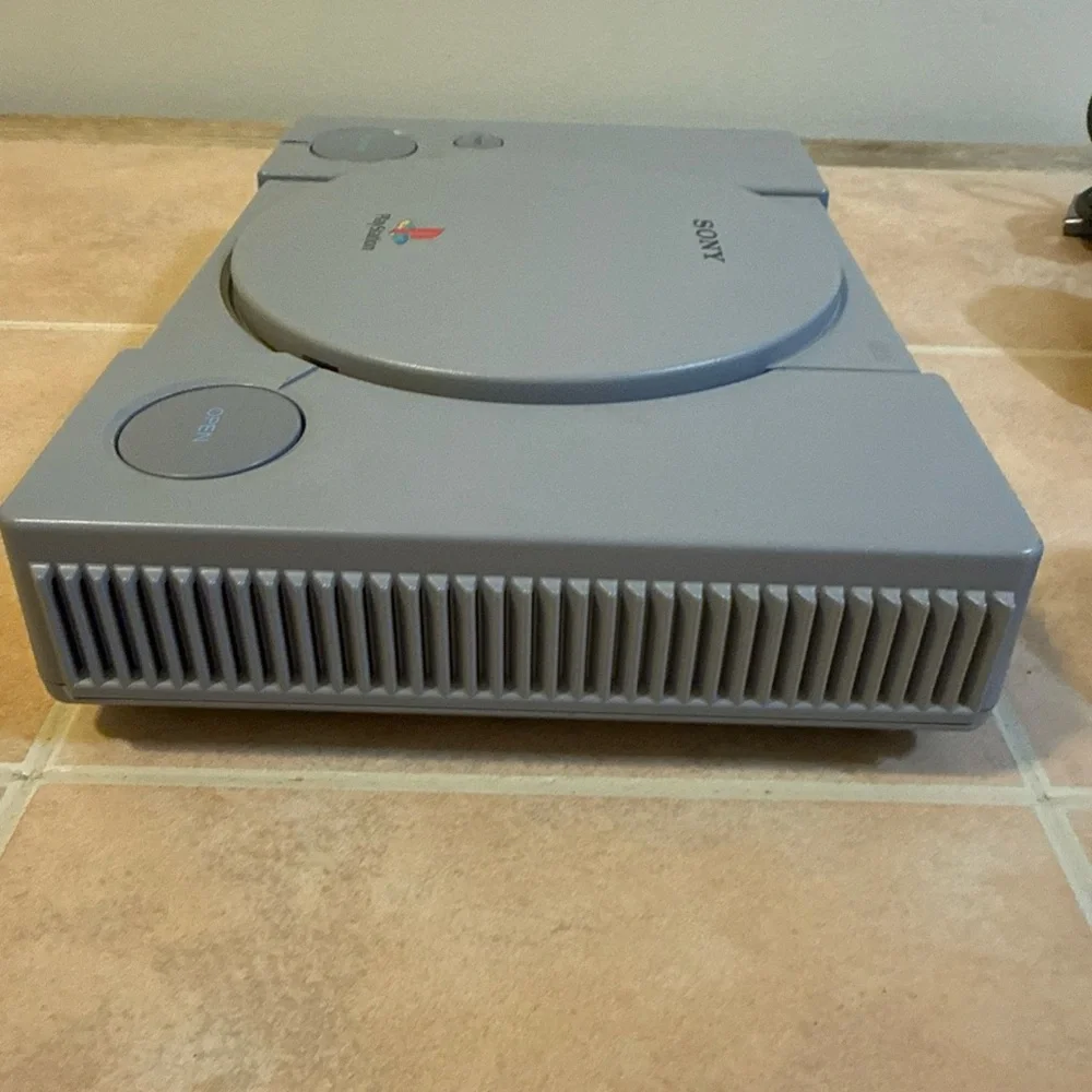 Sony Gray PlayStation Console with Two Wired Gray Controllers